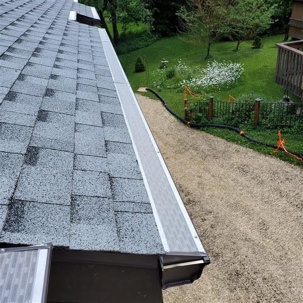 Professional seamless gutter installation on residential home roof showing quality workmanship